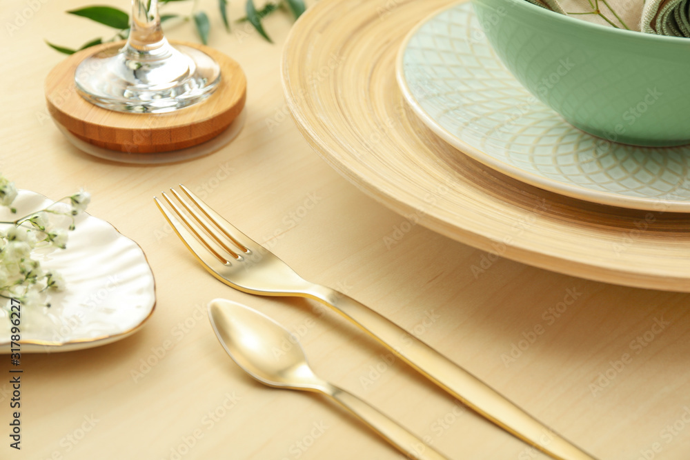 Elegant table setting with with golden cutlery, closeup Elegant table setting with with golden cutlery, closeup