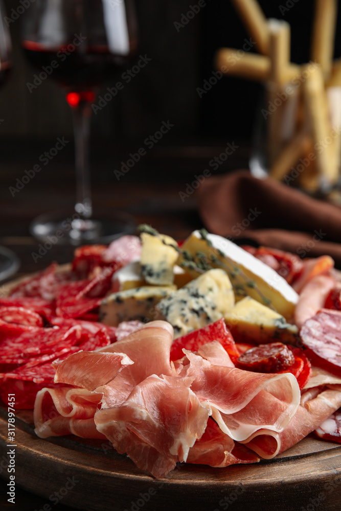 Tasty prosciutto with other delicacies served on table