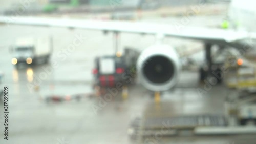 Wallpaper Mural Blurred background of the work of preparation the plane in the raining environment. Footage show the blinking lights signal. Torontodigital.ca