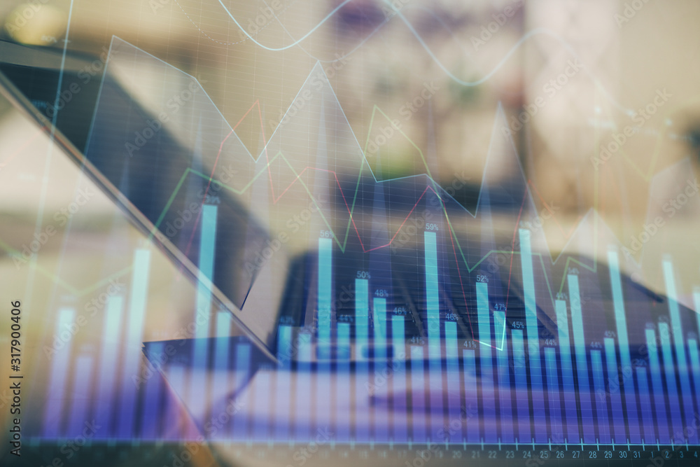 Forex graph hologram on table with computer background. Double exposure. Concept of financial markets. Forex graph hologram on table with computer background. Double exposure. Concept of financial markets.