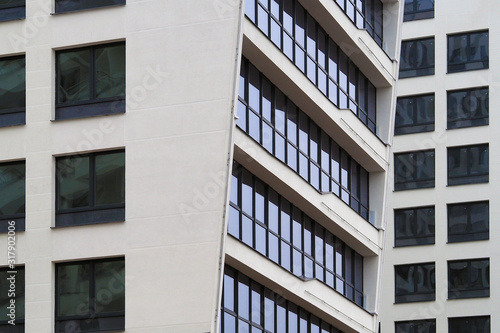 The windows of a multistory building are angled. fragment of a multi-storey residential building