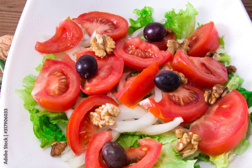 Vegetable salad with nuts and olives, diet and health concept