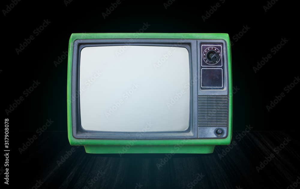 Retro old green television receiver on table front gradient green wall background.vintage tv with cut screen on perspective wooden floor.. Retro old green television receiver on table front gradient green wall background.vintage tv with cut screen on perspective wooden floor..