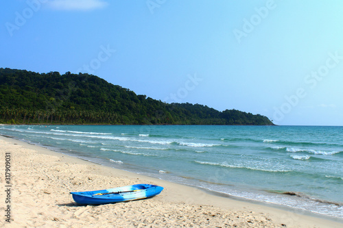 boat on a sunny sandy seashore © Elena