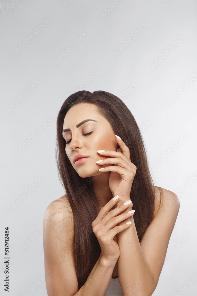 Beautiful woman with a French manicure nail , skin care concept, beautiful skin. Portrait of female hands with manicure nails. Сare for hands and nails and cosmetics Beautiful woman with a French manicure nail , skin care concept, beautiful skin. Portrait of female hands with manicure nails. Сare for hands and nails and cosmetics