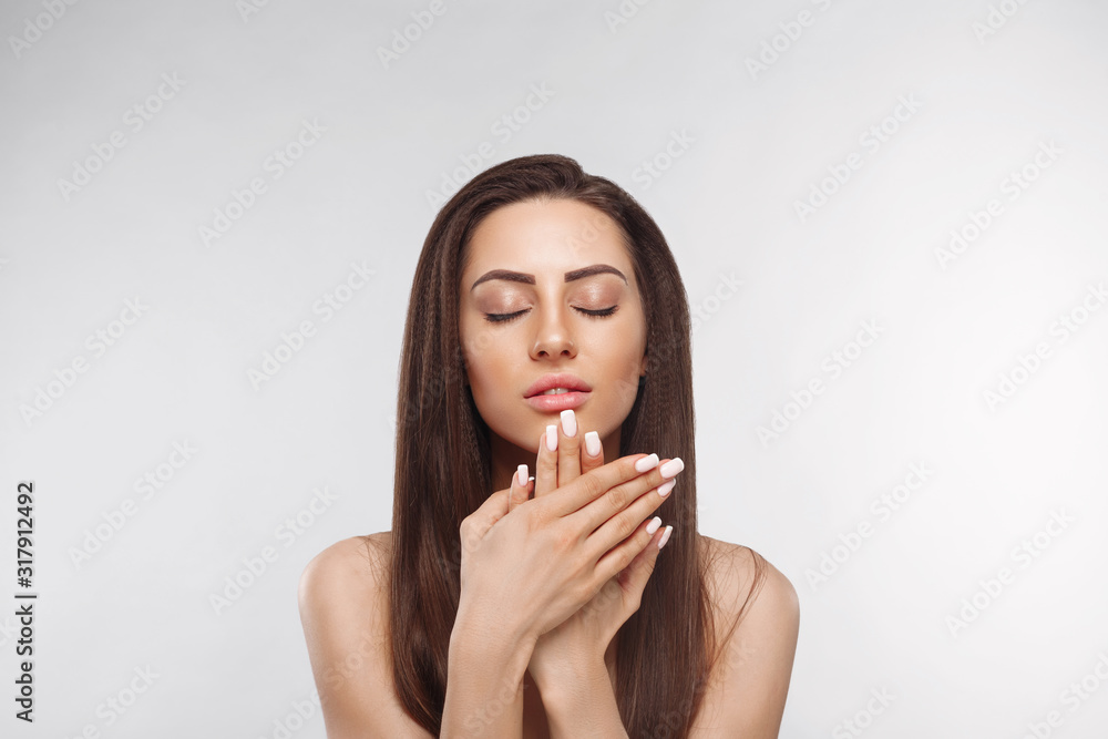 Beautiful woman with a French manicure nail , skin care concept, beautiful skin. Portrait of female hands with manicure nails.  Сare for hands and nails and cosmetics