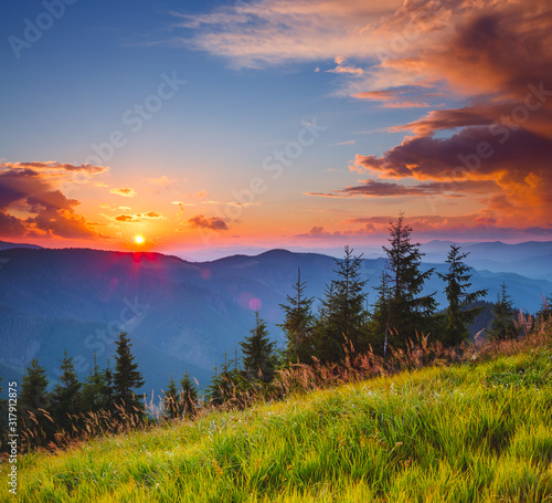 Perfect evening landscape in the mountains at sunset. Colorful cloudy sky.