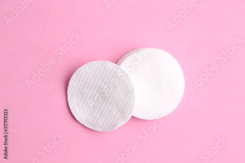 Cleansing cotton discs in colorful background photo