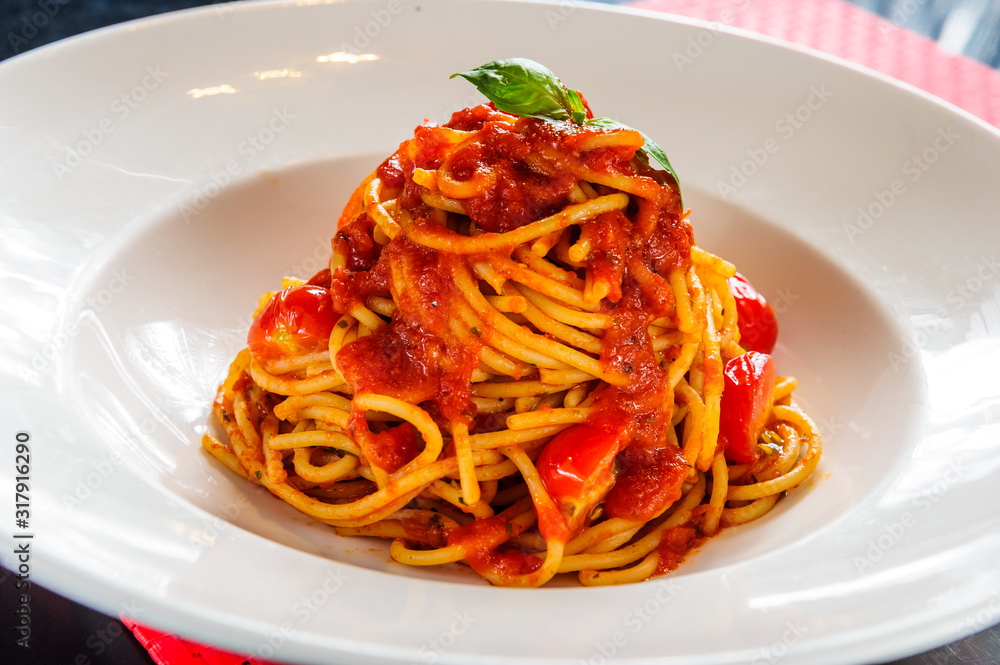 Spaghetti whit tomato sauce on white plate.Italian dish. Spaghetti whit tomato sauce on white plate.Italian dish.