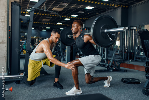 Fotografia, Obraz Muscular sportsman and trainer on training in gym