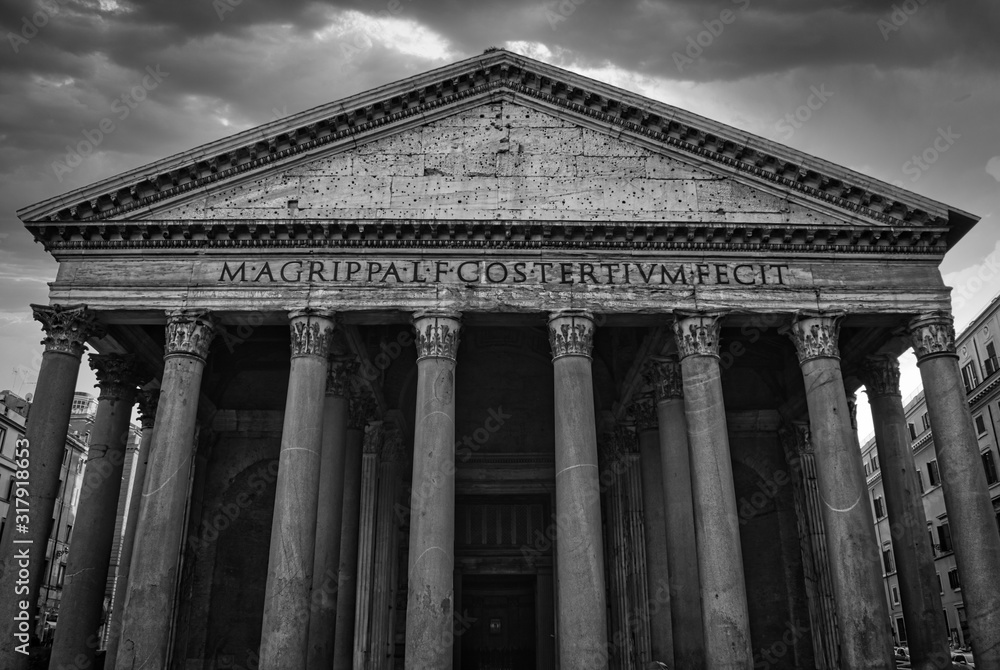 Front view of Pantheon in Rome, black and whit dramatic could sky in the background.