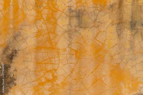 Yellow old cracked wall background. Abstract grunge wallpaper