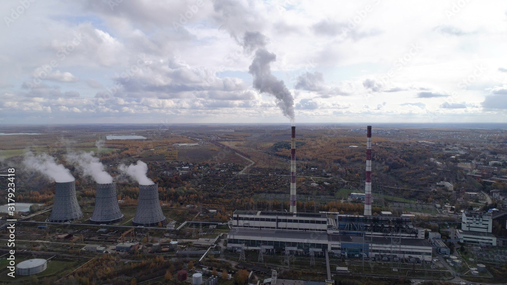 State District Power Station generating heat and electricity. High pipes and cooling towers are visible. Aerial view. State District Power Station generating heat and electricity. High pipes and cooling towers are visible. Aerial view.