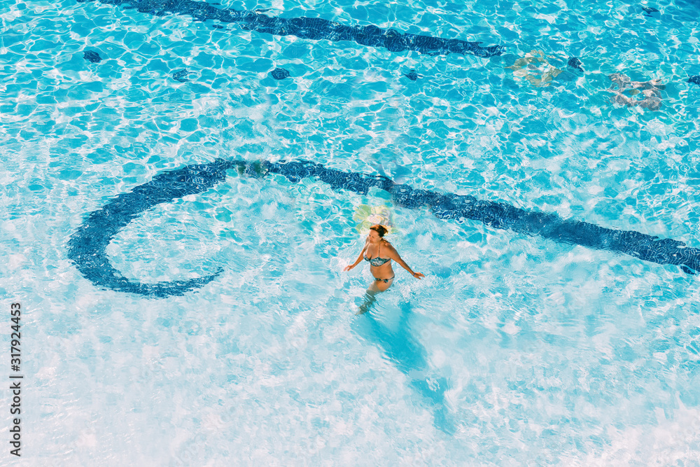 Adult Caucasian Lady Woman Standing In Hotel Swimming Pool In Sunny Summer Day. Vacation In Hotel