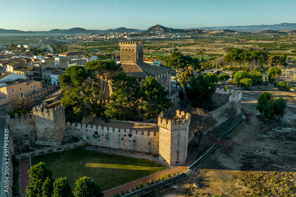Aerial morning view of fully restored Besano castle in Valencia with battlements, towers and a keep in Spain