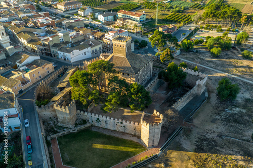 Fototapeta Naklejka Na Ścianę i Meble -  Aerial morning view of fully restored Besano castle in Valencia with battlements, towers and a keep in Spain