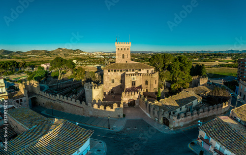 Aerial morning view of the gate and donjon of fully restored Gothic castle in Benisano Valencia province Spain