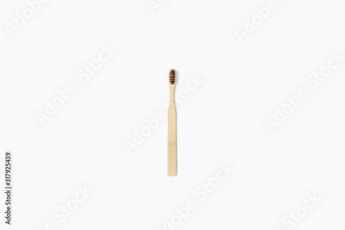 Zero waste picture. Wooden toothbrush on isolated white background. Flat lay, top view.