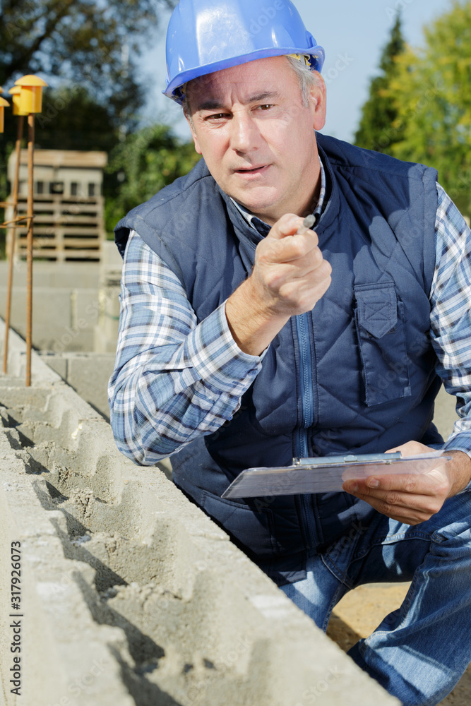 man engineer with clipboard while looking at camera man engineer with clipboard while looking at camera