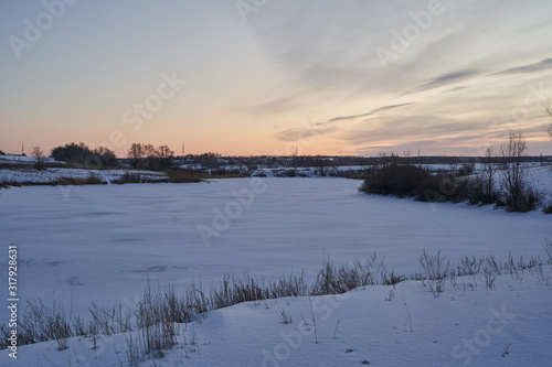 Winter landscape-frosty trees in a snow-covered birch forest on a Sunny morning. Calm winter nature in sunlight