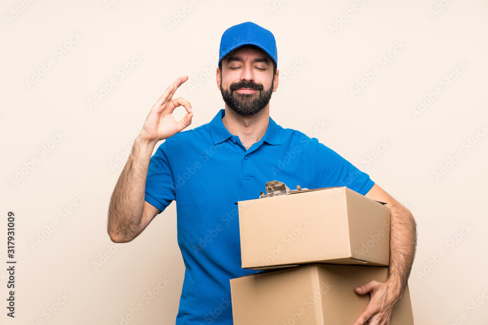 Delivery man with beard over isolated background in zen pose Delivery man with beard over isolated background in zen pose