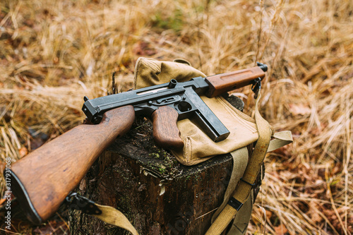 American Submachine Weapon Of World War II On Forest Sump
