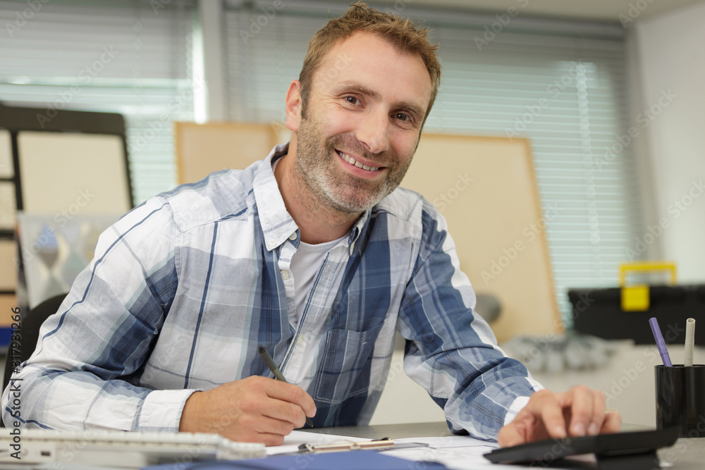 a male workshop designer smiling a male workshop designer smiling