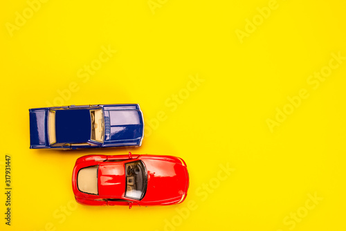 two toys cars on yellow background