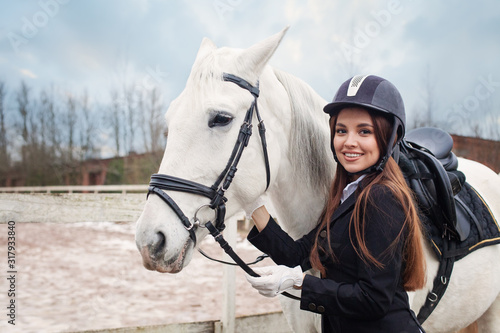 Happy beautiful woman with horse outdoors