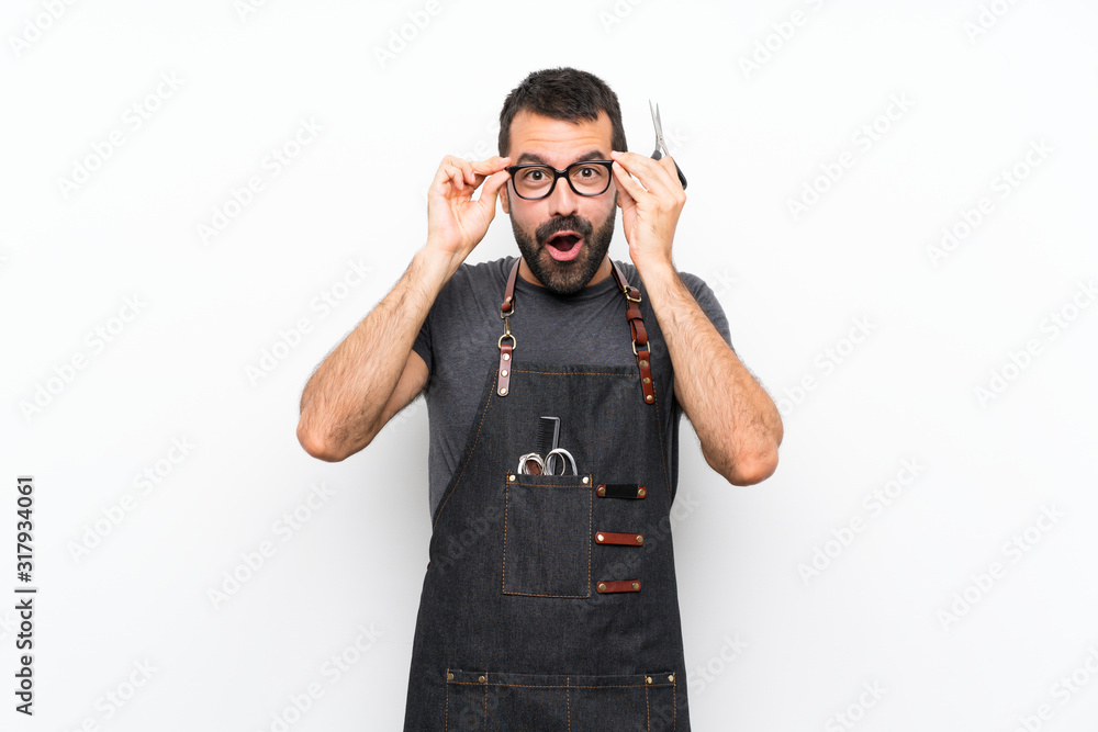 Barber man in an apron with glasses and surprised Barber man in an apron with glasses and surprised