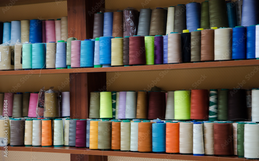 Multi-colored bobbins of sewing thread Multi-colored bobbins of sewing thread