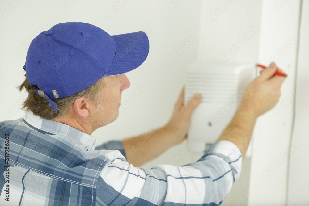 man using a pencil on machine