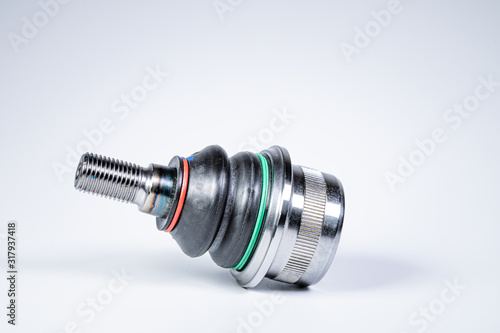 New spare parts spherical ball joints of a suspension bracket of a car on a gray background