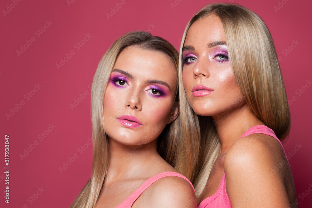 Perfect women faces. Pink lips, eyeshadow makeup on pink background Perfect women faces. Pink lips, eyeshadow makeup on pink background