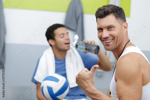 happy coach and player talking in changing room