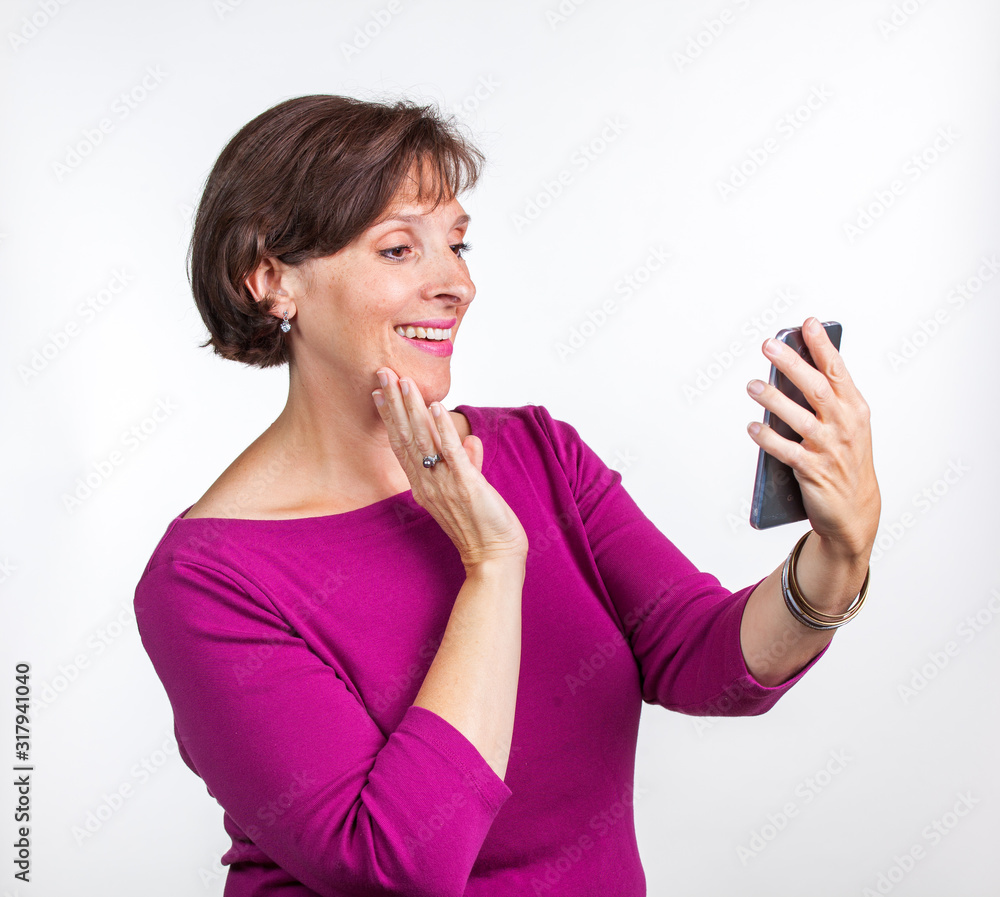 Middle Aged woman taking a selfie Middle Aged woman taking a selfie