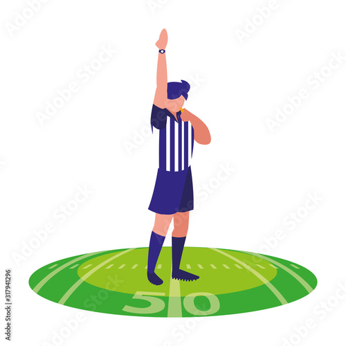 american football referee with his hand up on stadium grass