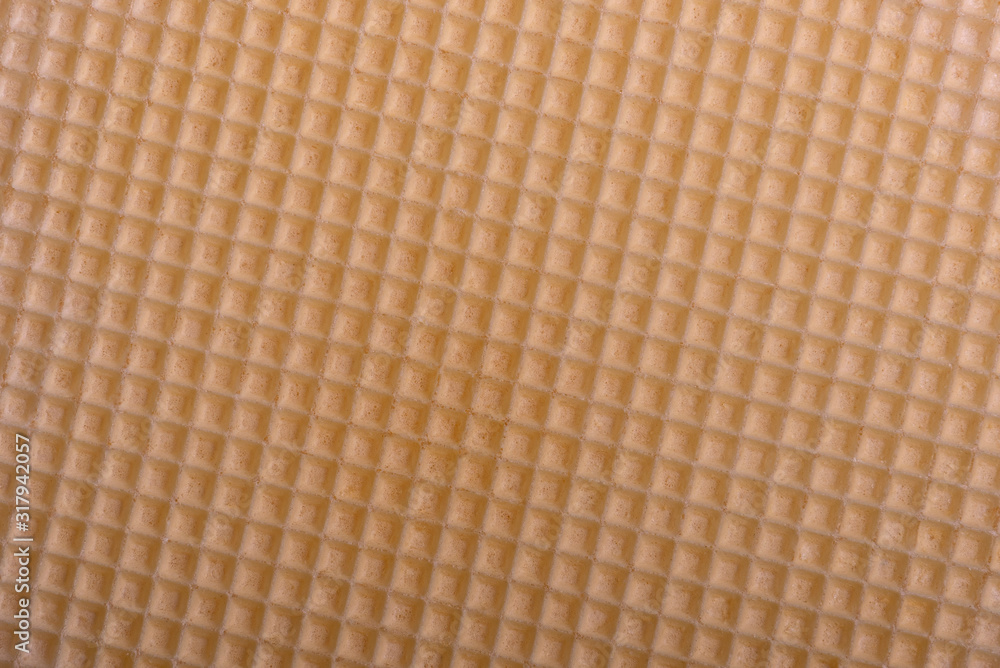 Part of wafer cake layer with cream from condensed milk and butter. Wafer background Part of wafer cake layer with cream from condensed milk and butter. Wafer background