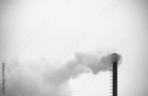 emissions from factory chimney smokestack. winter