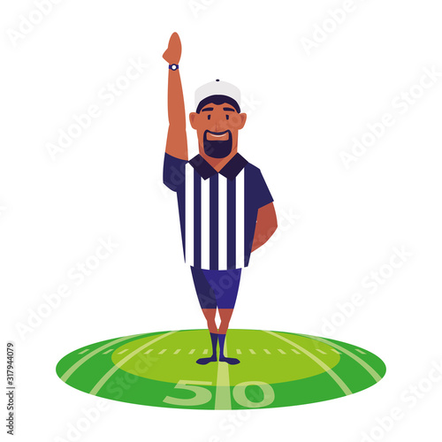 american football referee with his hand up on stadium grass