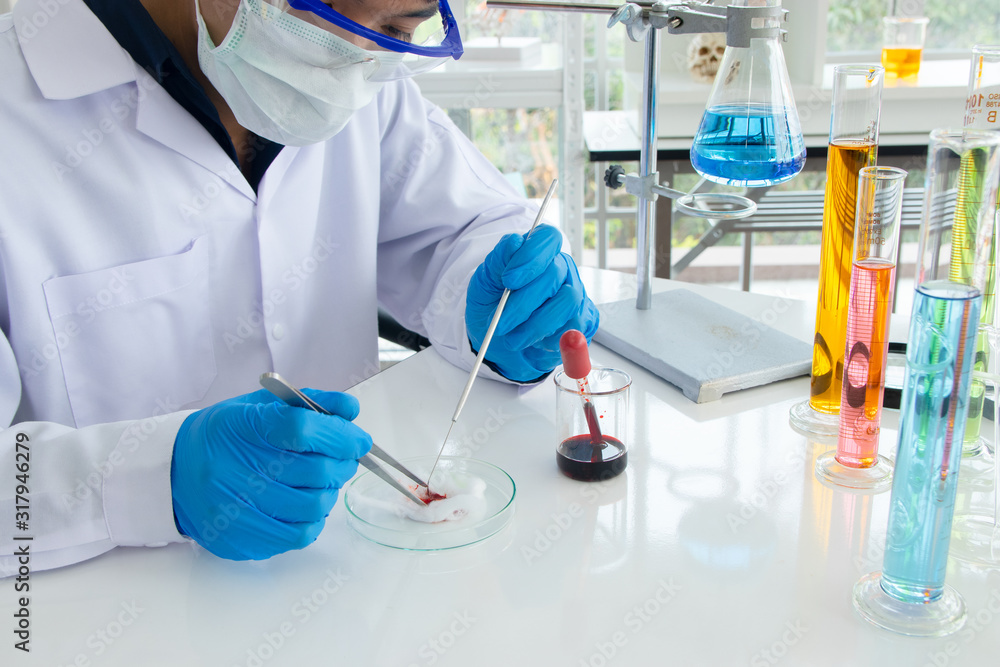 Scientists or doctors are testing bloods to prevent and destroy new strains of the virus through tube and beaker. Researching and experimenting for effective chemicals. Scientists or doctors are testing bloods to prevent and destroy new strains of the virus through tube and beaker. Researching and experimenting for effective chemicals.