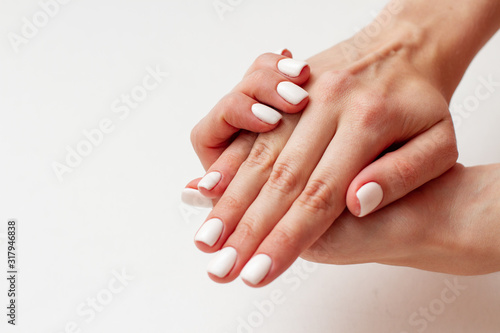 gentle female hands with a beautiful gel polish manicure