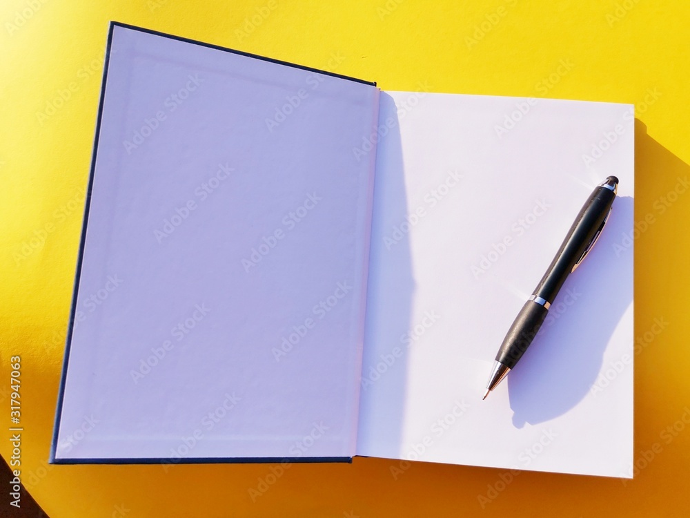 notebook, pen, on yellow background. top view copy space notebook, pen, on yellow background. top view copy space