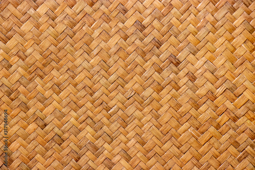 pattern of brown woven reed mat texture background, basketry crafted by Thai people. pattern of brown woven reed mat texture background, basketry crafted by Thai people.