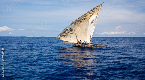 Patched sail on a pirogue of native fishermen in Nosy Be, Madagascar