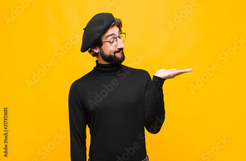 Принти на полотні young french artist man feeling happy and smiling casually, looking to an object