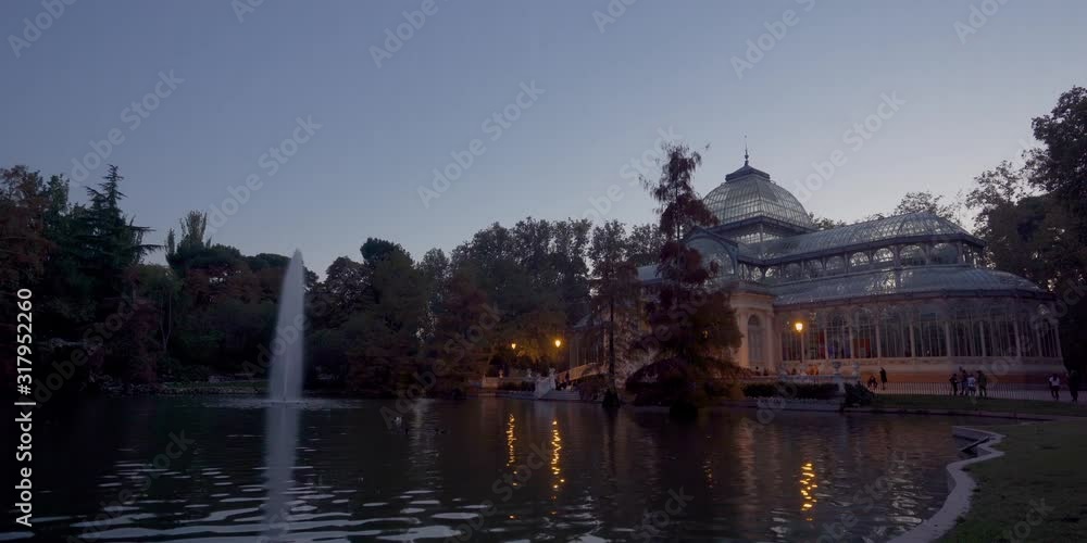 Sunset view of Crystal Palace or Palacio de cristal in Retiro Park in Madrid, Spain. The Buen Retiro Park is one of the largest parks of the city of Madrid, Spain Sunset view of Crystal Palace or Palacio de cristal in Retiro Park in Madrid, Spain. The Buen Retiro Park is one of the largest parks of the city of Madrid, Spain