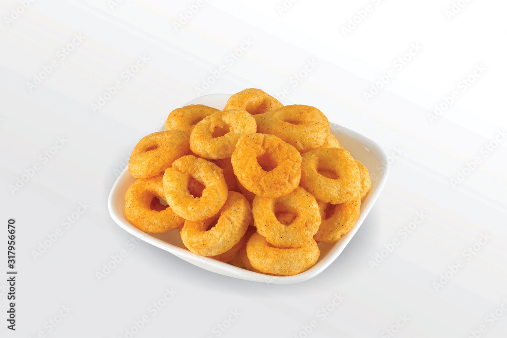 Pile of crispy Masala Corn ring, Cream & Chilli snack (Fryums - Frymus) in white dish isolated on white background, Sweet brekfast cereal rings - Image