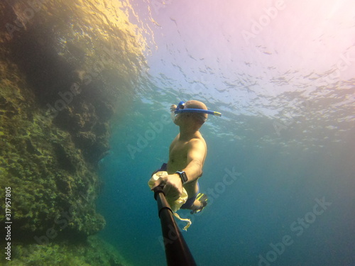 underwater man snorkeling in the sea withcrystal-clear waters concept of holiday relax summer beach diver in the sea © Enrique
