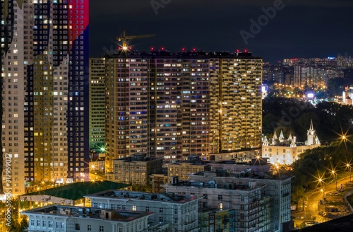 Commuter town in night lights. Pavshino district of Krasnogorsk, Moscow region, Russia. Entire street is newly built in development area with numerous residential buildings. Moscow suburb photo